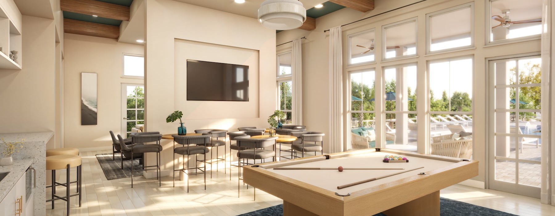 a large lounge with seating pool table and tv