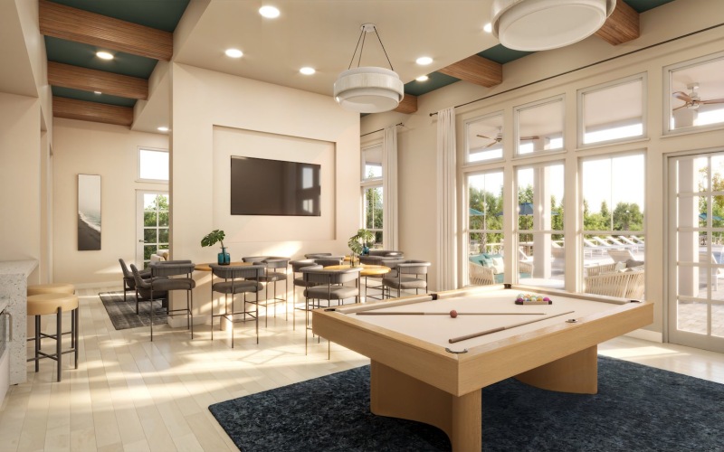 a large lounge with seating pool table and tv